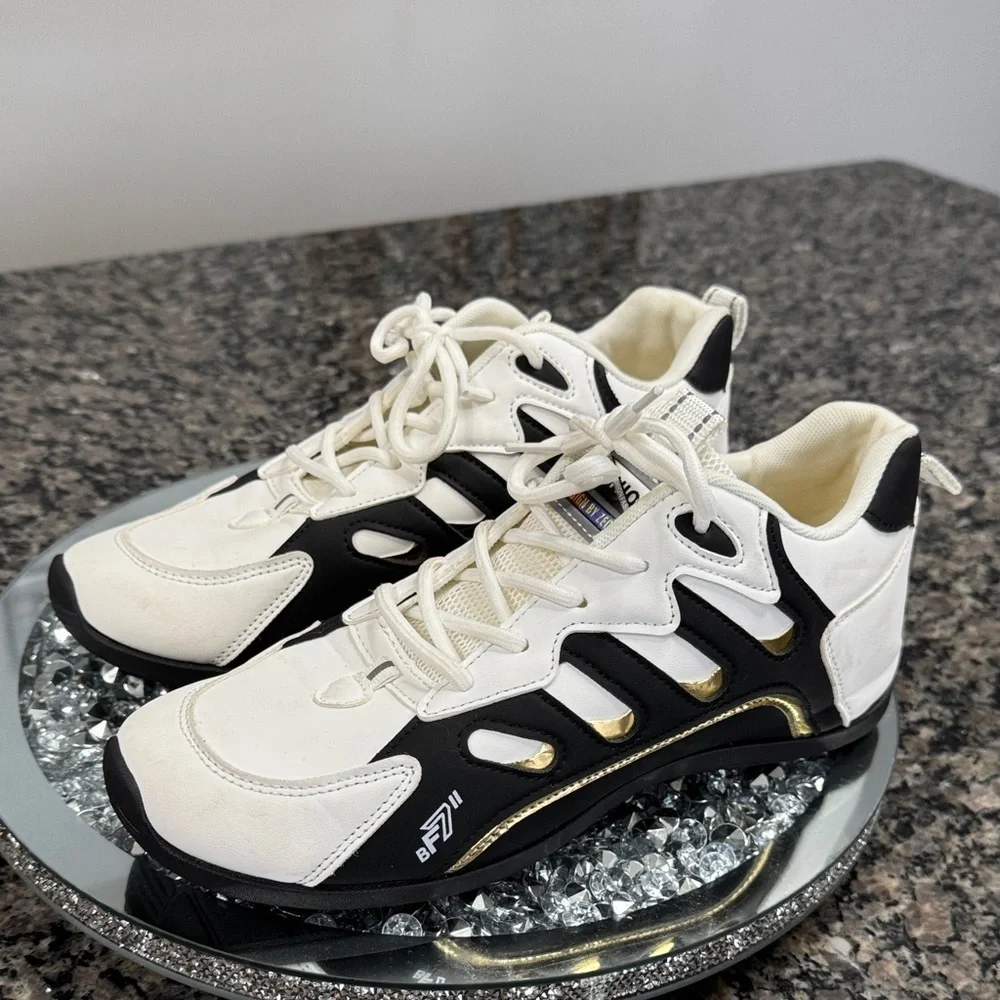 White and Black womens fashion Sneakers with gold accents EUC 10